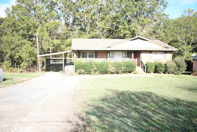 ranch-style home featuring a front yard and a carport