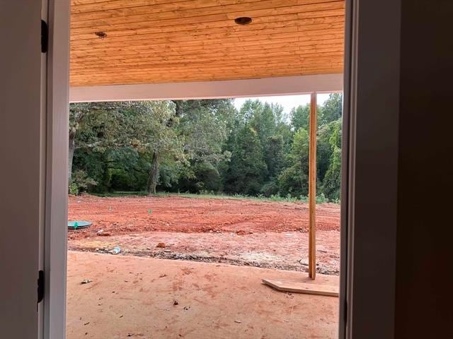 doorway with wood ceiling