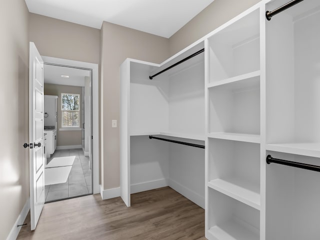 walk in closet with light wood-type flooring