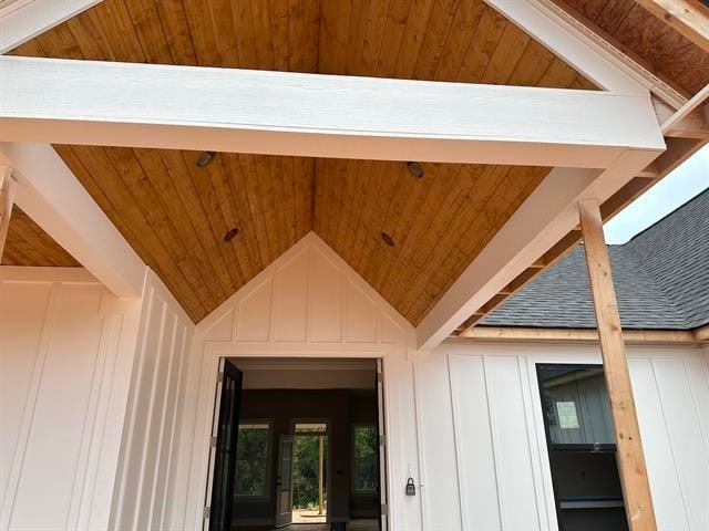 exterior details featuring wood ceiling and beam ceiling