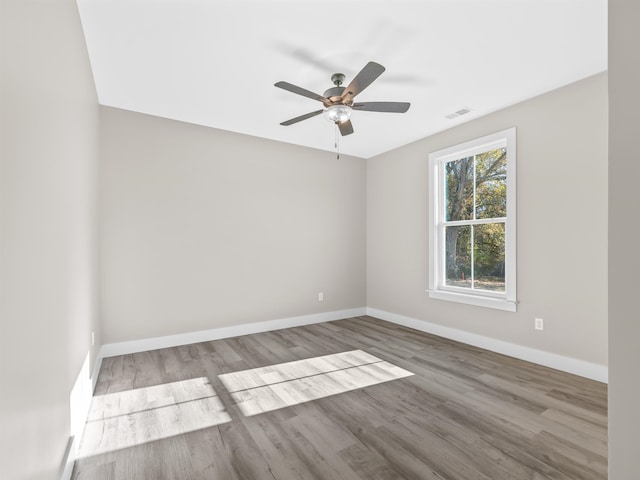 spare room featuring light hardwood / wood-style flooring and ceiling fan