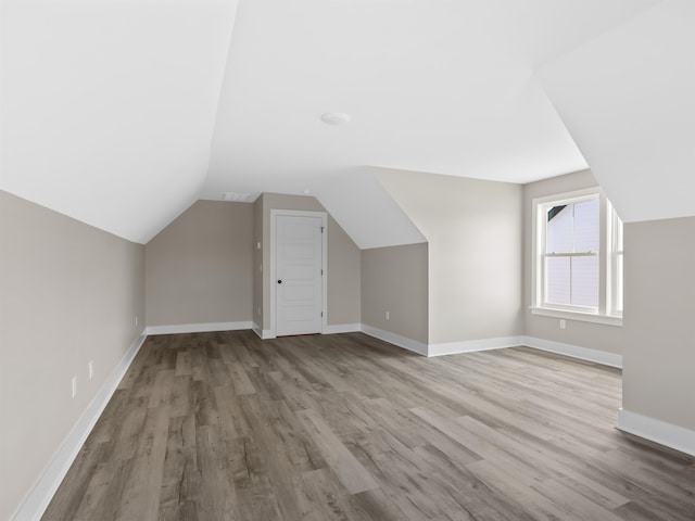 bonus room featuring wood-type flooring and lofted ceiling