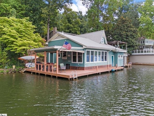 rear view of house featuring a water view