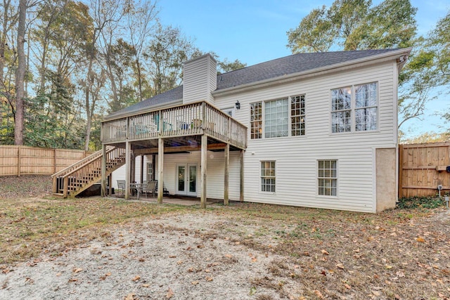 back of house featuring french doors and a wooden deck