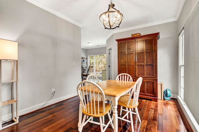 dining area with dark hardwood / wood-style flooring, ornamental molding, and a notable chandelier