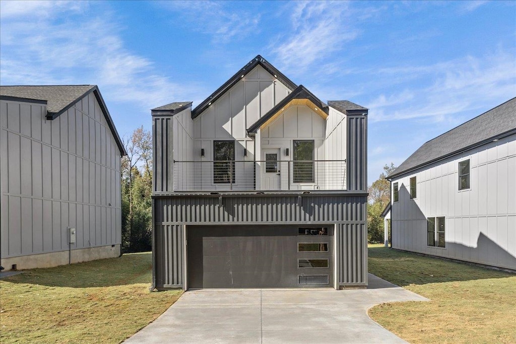 modern farmhouse style home with a garage, a balcony, and a front lawn