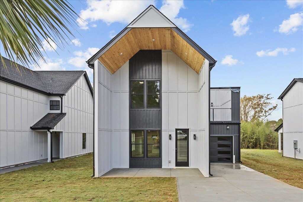 exterior space with a garage and a lawn