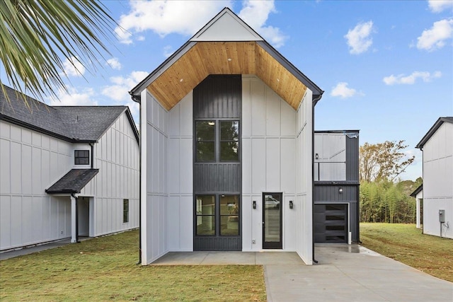 exterior space with a garage and a lawn