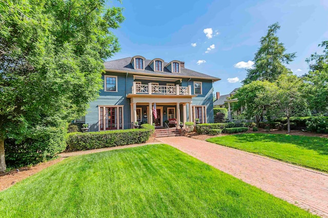 view of front of home with covered porch and a front yard