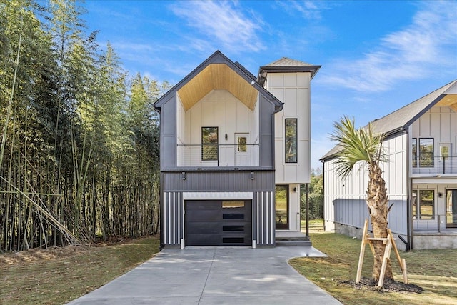 view of front of house featuring a garage, a front lawn, and a balcony