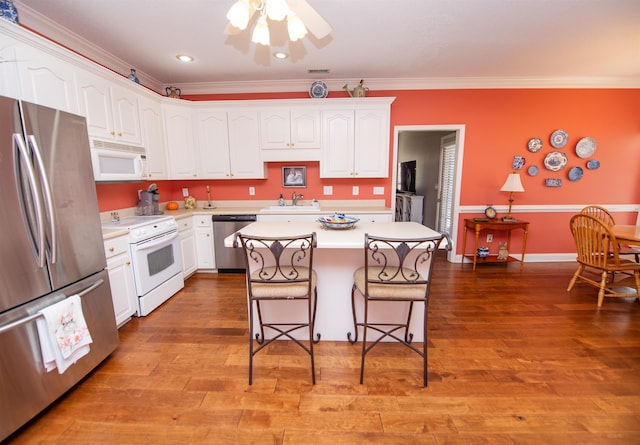 kitchen featuring stainless steel appliances, hardwood / wood-style flooring, and a center island