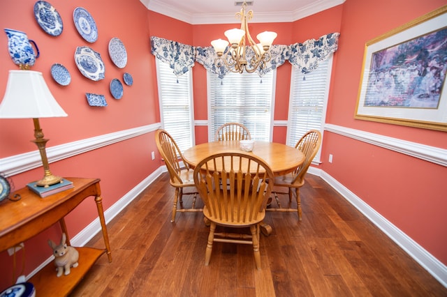 dining room with wood-type flooring, a notable chandelier, and ornamental molding