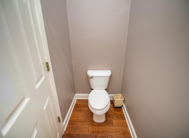 bathroom featuring hardwood / wood-style floors and toilet