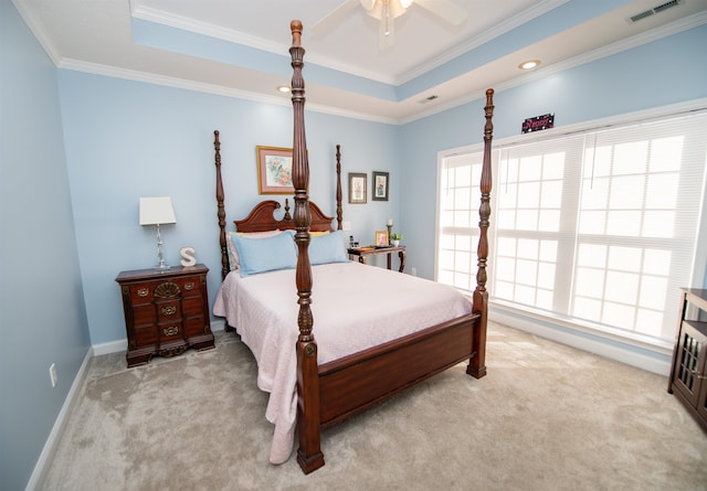 bedroom with a raised ceiling, light carpet, ceiling fan, and crown molding