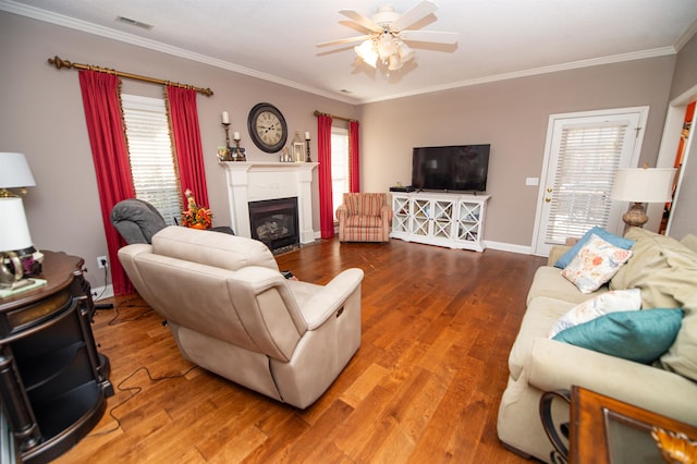 living room with ornamental molding, hardwood / wood-style floors, and ceiling fan