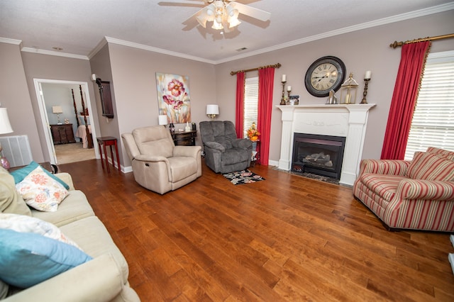 living room featuring ornamental molding, hardwood / wood-style flooring, and ceiling fan