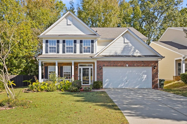 view of front facade with a garage, a front lawn, and covered porch