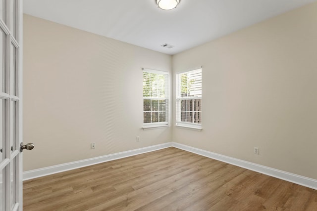 unfurnished room with light wood-type flooring