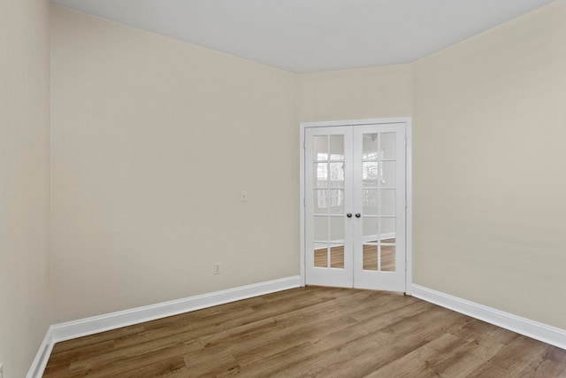 unfurnished room featuring light hardwood / wood-style floors and french doors