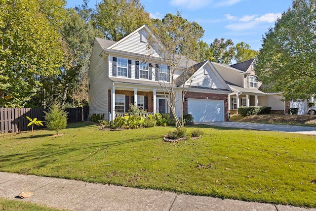 view of front facade featuring a garage, a front lawn, and covered porch