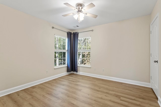 empty room with light hardwood / wood-style flooring and ceiling fan