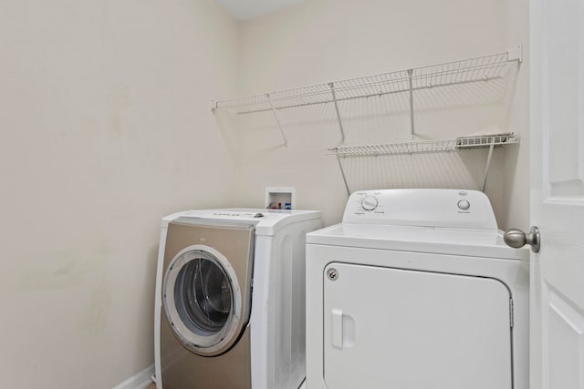 washroom with independent washer and dryer