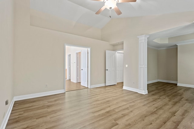 unfurnished bedroom featuring light hardwood / wood-style floors, ceiling fan, crown molding, lofted ceiling, and ornate columns