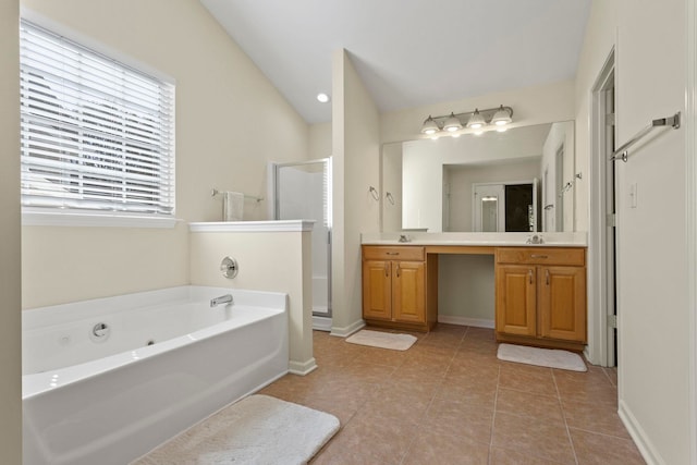 bathroom with tile patterned flooring, shower with separate bathtub, vanity, and vaulted ceiling