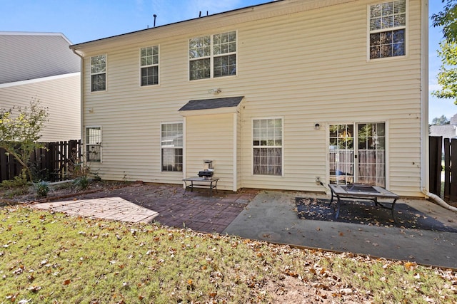 rear view of house with a yard and a patio