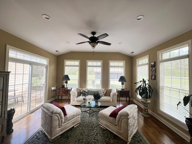 living room featuring hardwood / wood-style flooring, ceiling fan, and vaulted ceiling