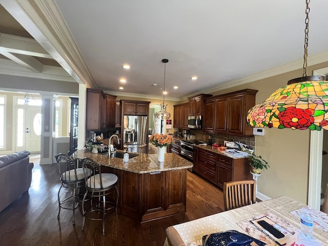 kitchen featuring decorative backsplash, stainless steel appliances, decorative light fixtures, and dark hardwood / wood-style flooring