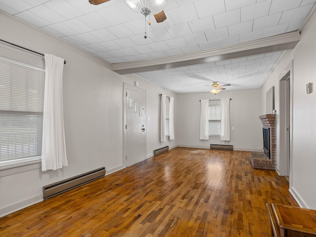 unfurnished living room featuring baseboard heating and hardwood / wood-style flooring