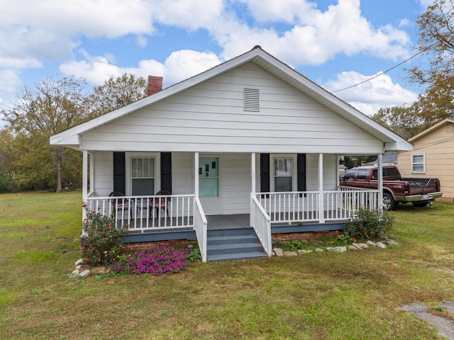 bungalow featuring a front lawn and a porch