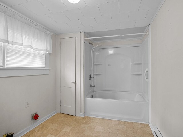 bathroom with baseboard heating and shower / bathtub combination