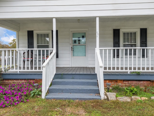 view of exterior entry with a porch