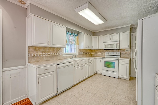 kitchen featuring white cabinets, white appliances, and ornamental molding