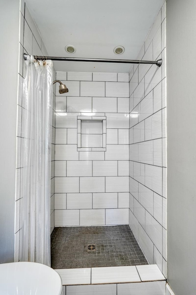 bathroom with toilet and a shower with shower curtain