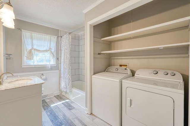 9 Brookdale Acres, Lyman, SC 29365 - washroom with washer and dryer, light wood-style flooring, a textured ceiling, ornamental molding, and wainscoting