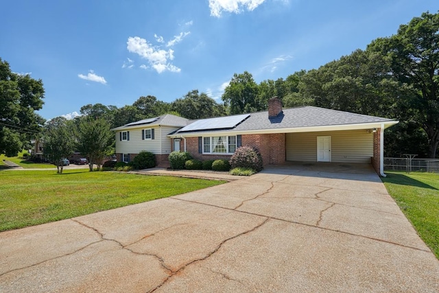9 Brookdale Acres, Lyman, SC 29365 - tri-level home featuring brick siding, driveway, solar panels, a chimney, and a carport