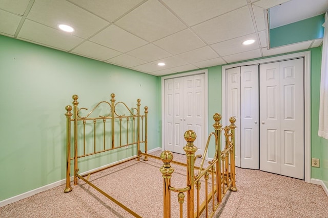 carpeted bedroom featuring a paneled ceiling