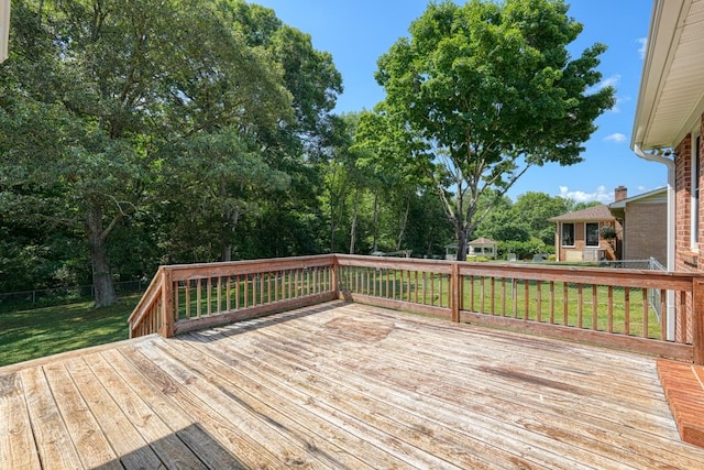 wooden deck featuring a lawn