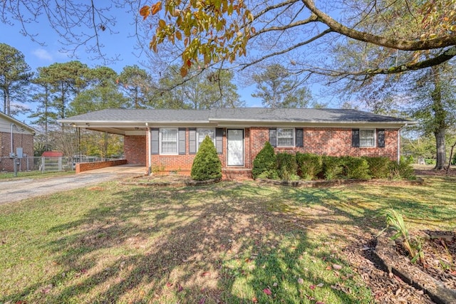 ranch-style home with a carport and a front lawn