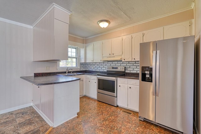 kitchen with white cabinetry, appliances with stainless steel finishes, wood walls, and tasteful backsplash