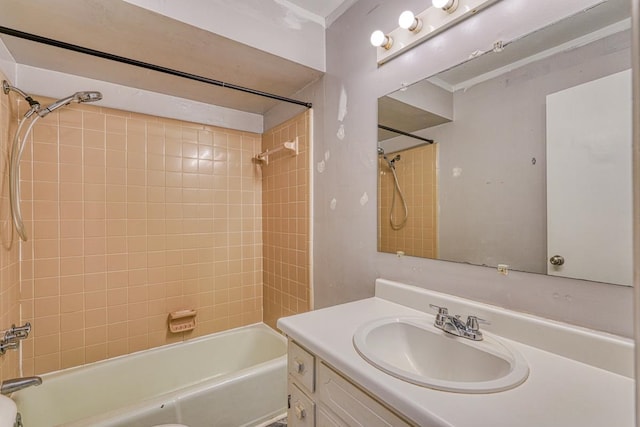 bathroom with tiled shower / bath and vanity