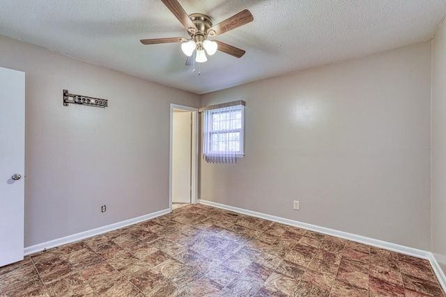 empty room with a textured ceiling and ceiling fan