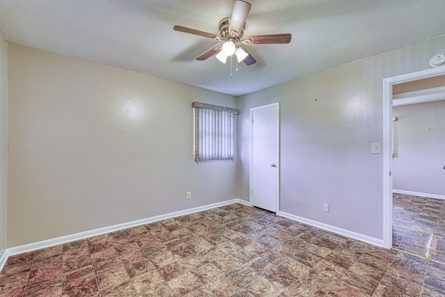 spare room featuring ceiling fan and a textured ceiling