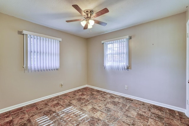 spare room with ceiling fan and a textured ceiling