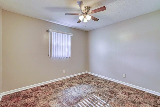 empty room featuring a textured ceiling and ceiling fan