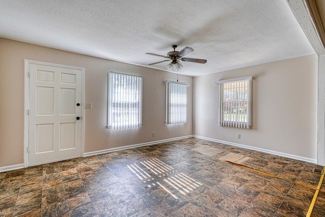 foyer featuring a textured ceiling and ceiling fan