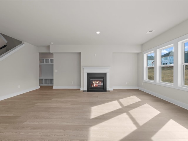 unfurnished living room with light wood-type flooring